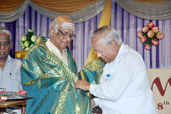 Dr.Nalli honouring P.S.Narayaswamy with a shawl and medal